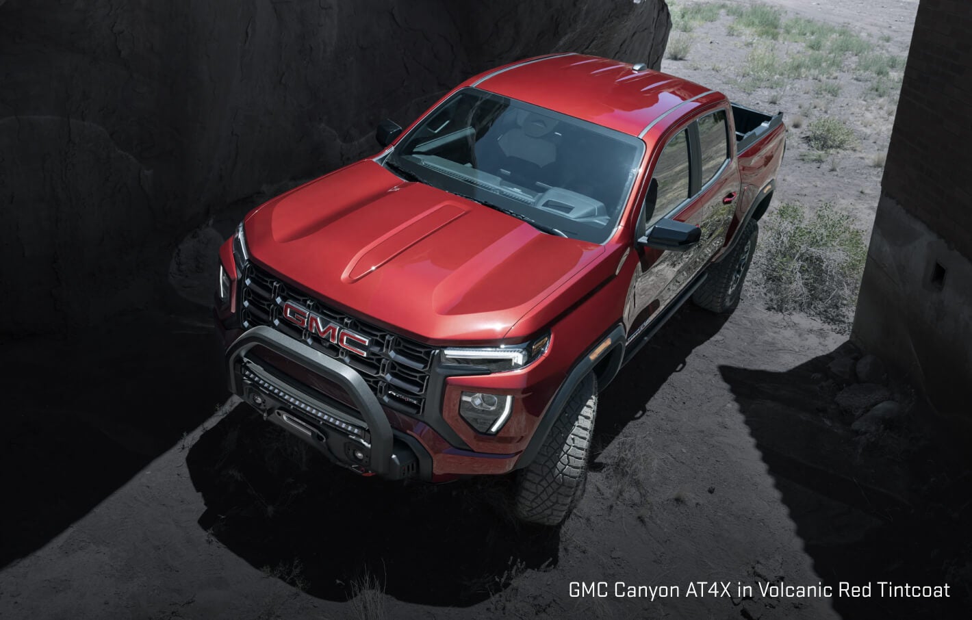 GMC Canyon AT4X exterior in Volcanic Red Tintcoat showing a high-angle view displaying a safari bar.